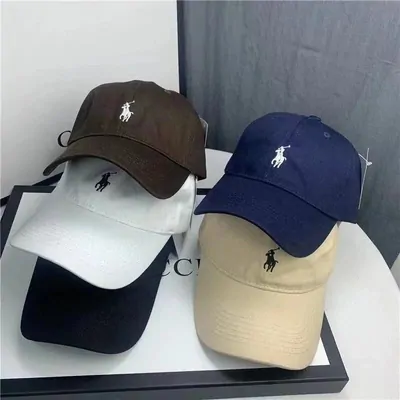 Five baseball caps arranged in two rows on a white surface, in brown, navy, white, black and sand