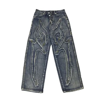 A pair of wide-leg blue denim jeans laid flat on a white surface, with a pale stitched pattern down each leg