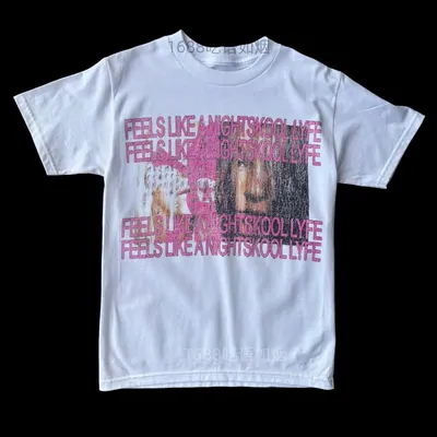 A white short-sleeved t-shirt on a hanger, printed with a block of pink text and a photo panel